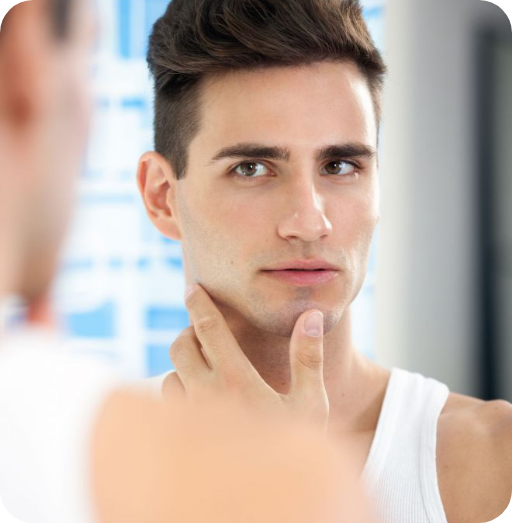handsome man looking and touching face in mirror